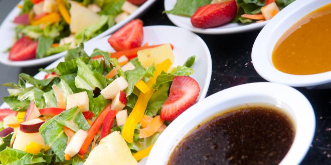 assorted fruit and vegetable salads with oil and dressing